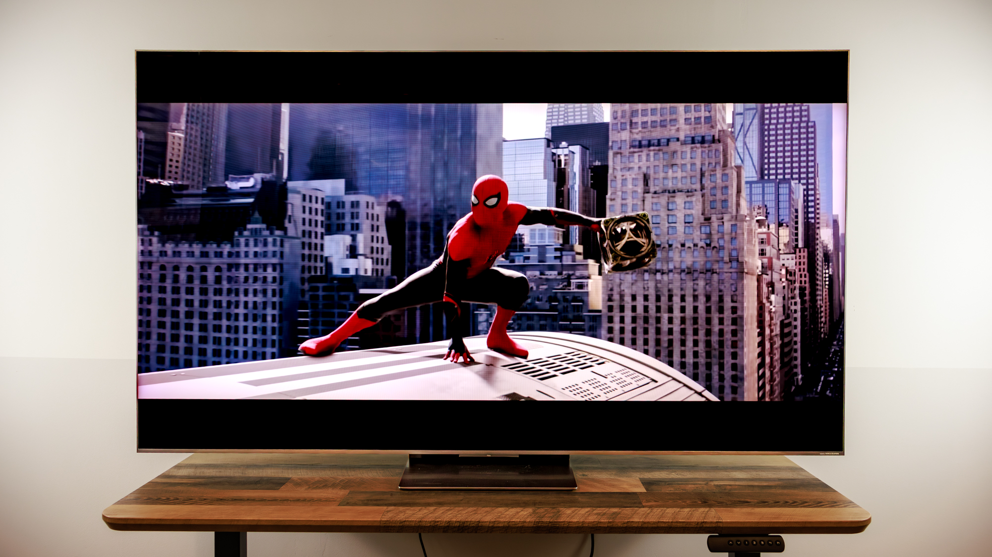 A 75-inch TCL QM8L TV on a desk