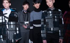 4 male models in dark clothing pose for the camera