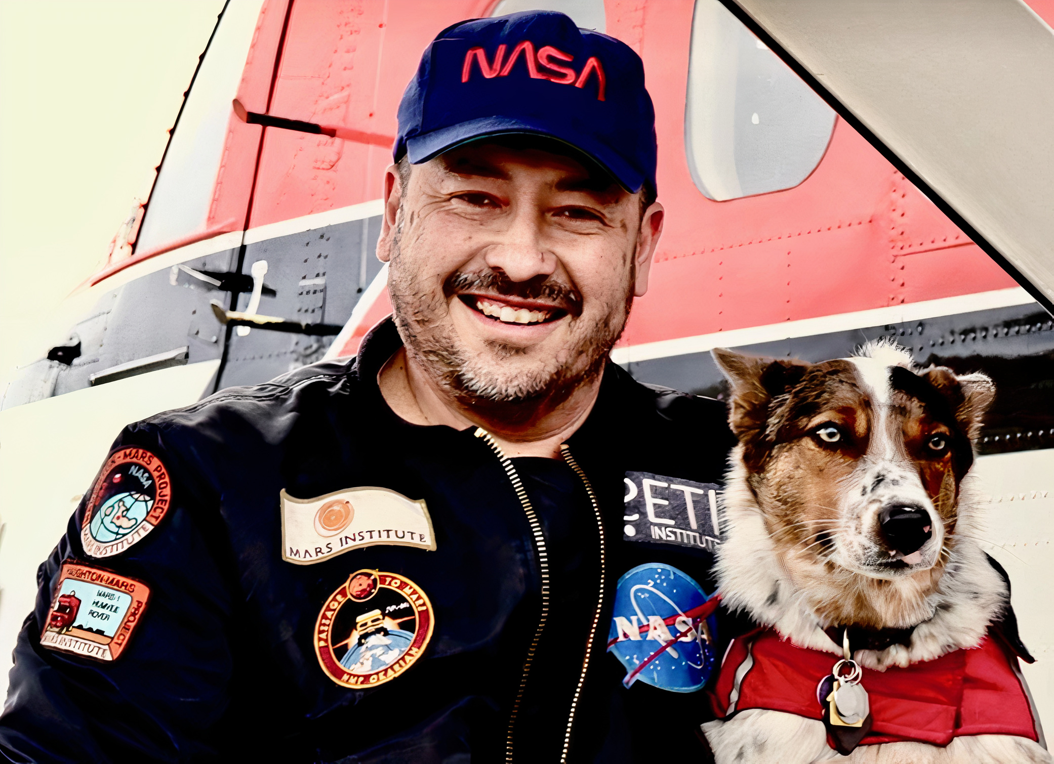 Pascal Lee smiles while holding his dog.