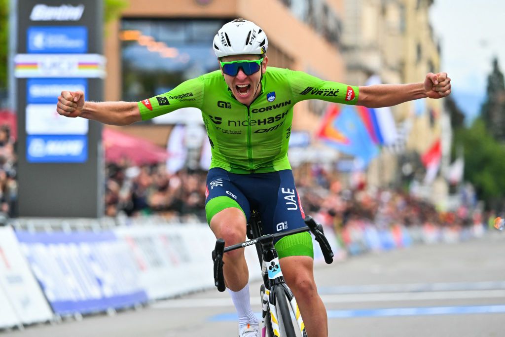 Slovenia's Tadej Pogacar celebrates as he crosses the finish line to win the men's Elite Road Race cycling event during the UCI 2024 Road World Championships, in Zurich, on September 29, 2024. (Photo by Fabrice COFFRINI / AFP)