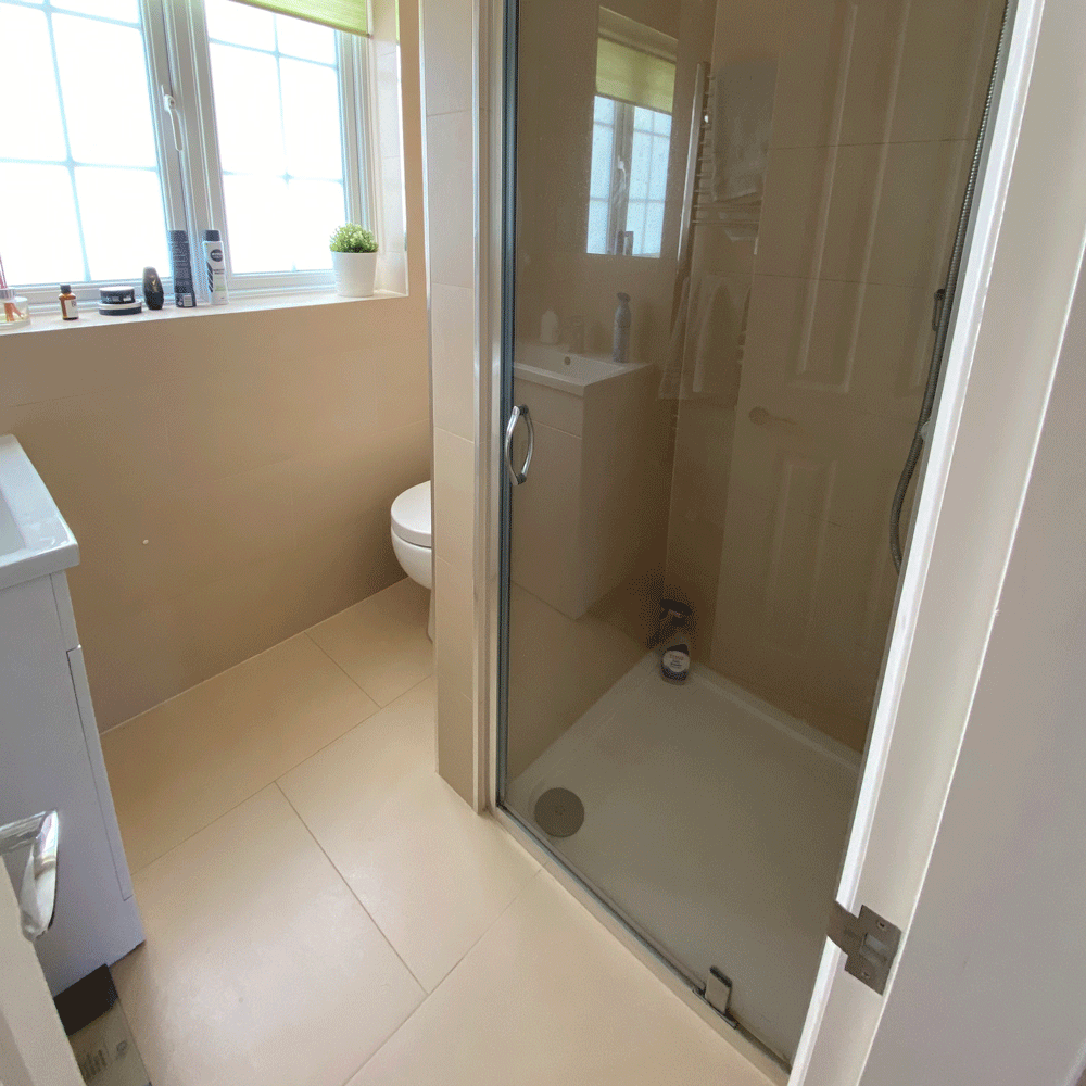 bathroom with glass door and white commode