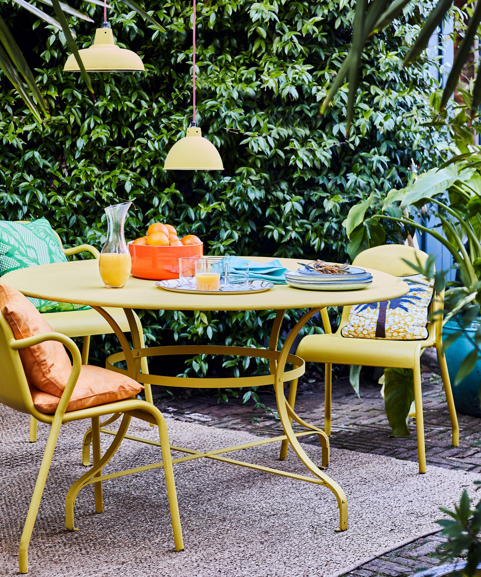 An outdoor dining setr painted yellow with outdoor chalk paint