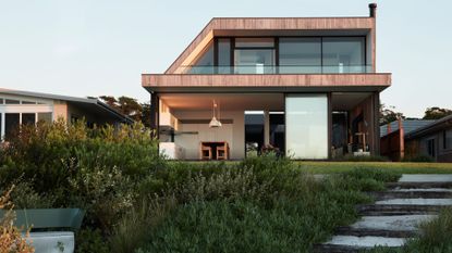 A large backyard leading to an outdoor seating space