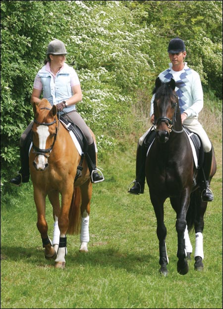 Carl Hester and Pippa Funnell relax on a hack