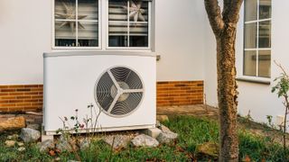 New air heat pump installed in front of family house, green renewable energy concept