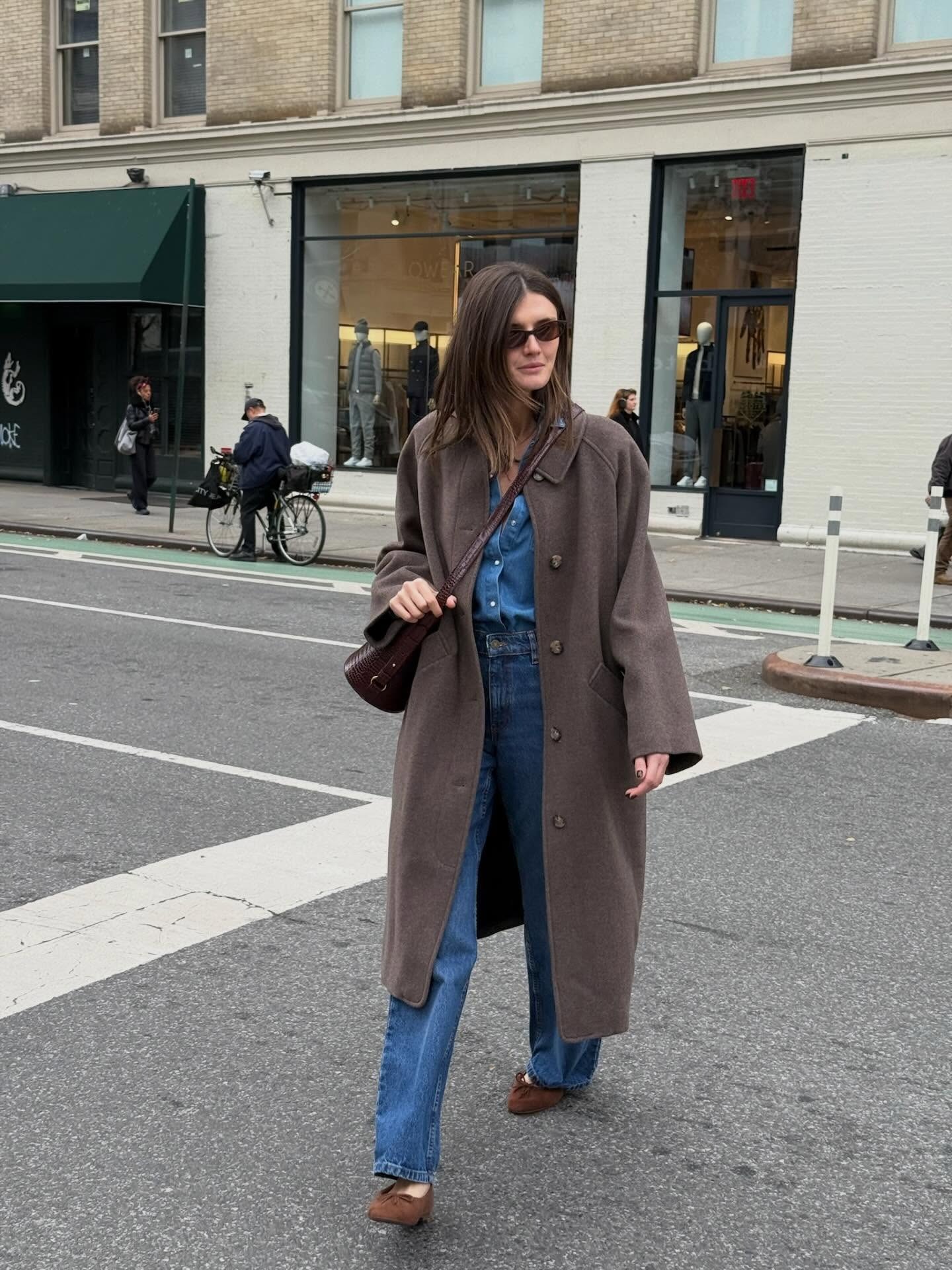 Influencer wearing a denim shirt with jeans and brown suede ballet flats.