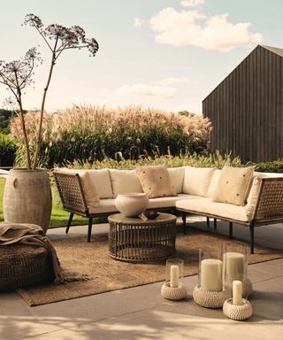 Outdoor furniture, L shaped sofa, rug, candles, planters