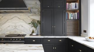 black kitchen units with marble surfaces