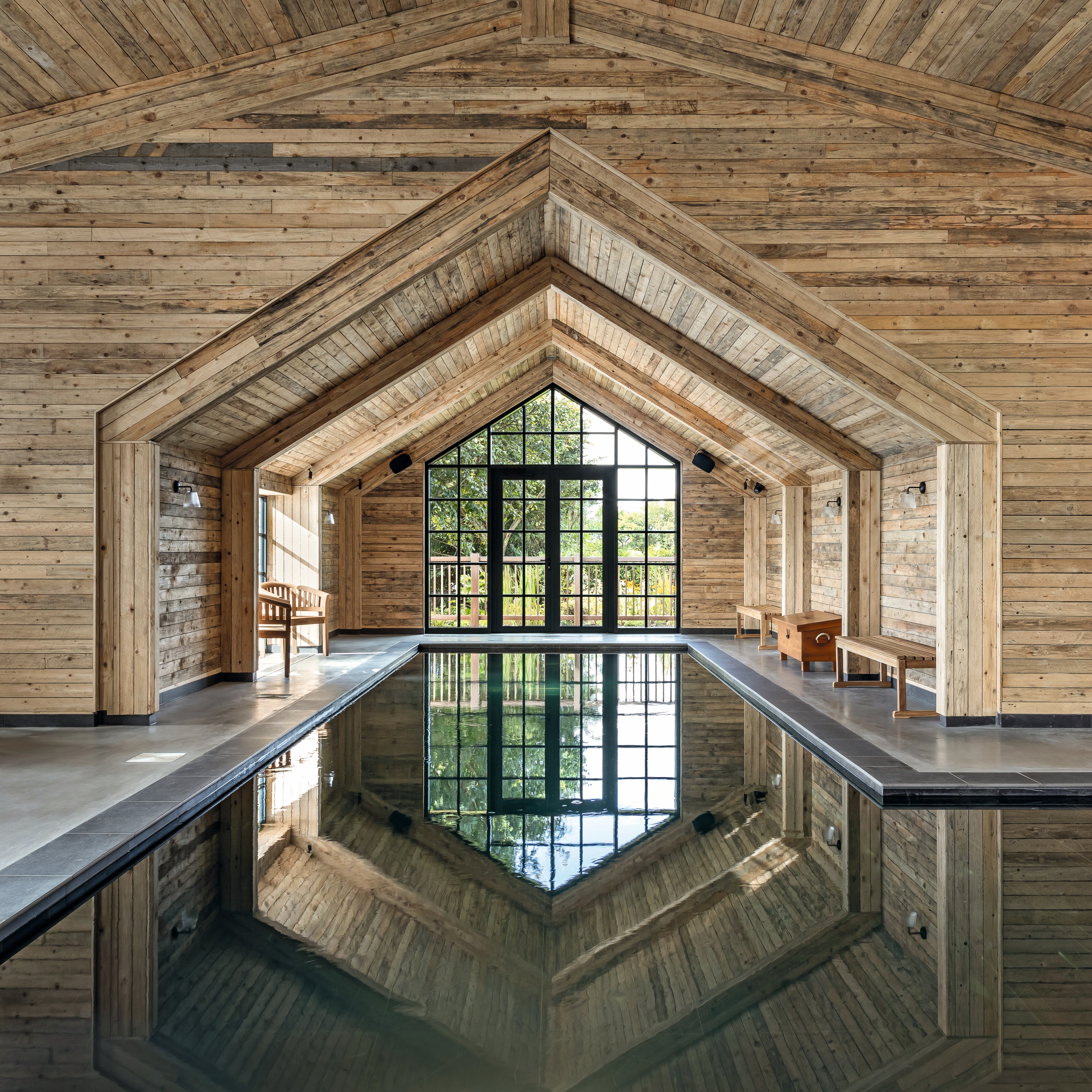 A winter retreat with wood-clad interiors, plush fabrics, warming fireplaces, and panoramic spas.