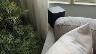 Amazon Fire TV Soundbar Plus rear speaker behind sofa