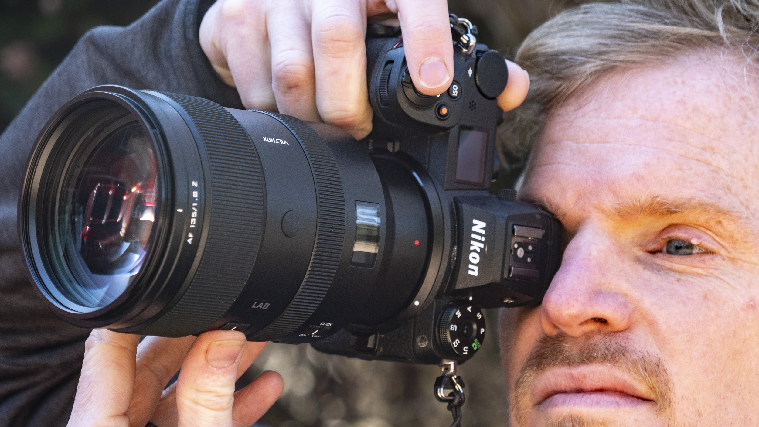 Viltrox 135mm F1.8 Lab lens for Nikon Z-mount, in the hand, attached to a Nikon Z6 II