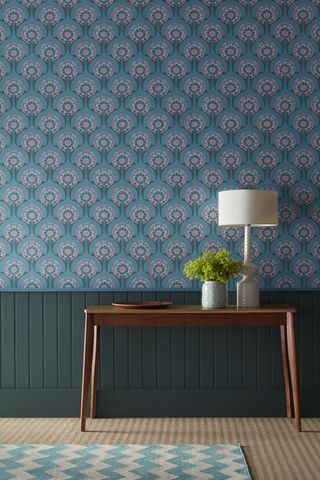blue wallpaper in entryway stylised floral design, console, shiplap, rug