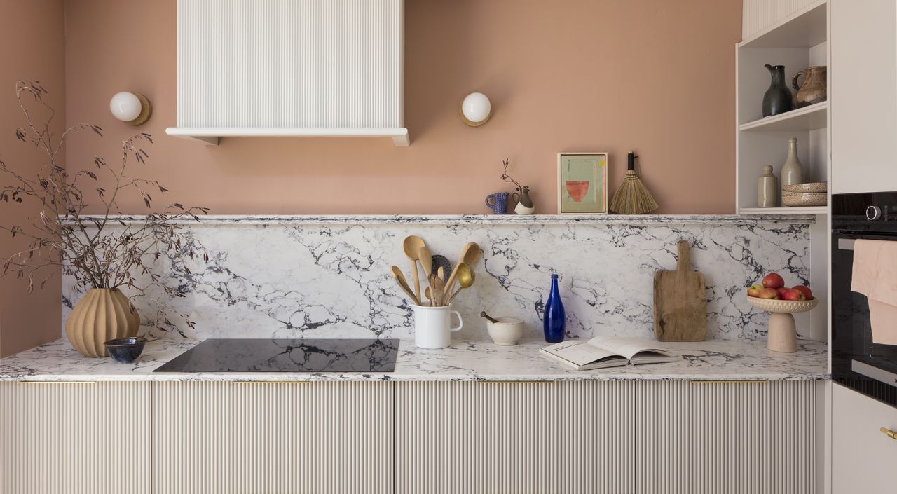 kitchen with peach walls and marble splashback