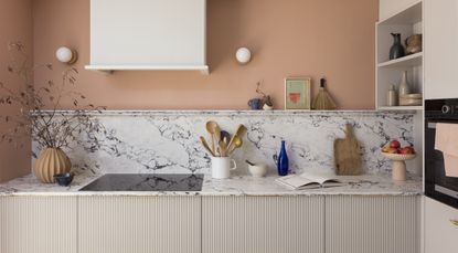 kitchen with peach walls and marble splashback