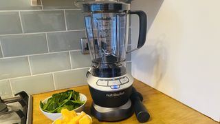 Nutribullet Blenderon a kitchen countertop with pineapple and spinach