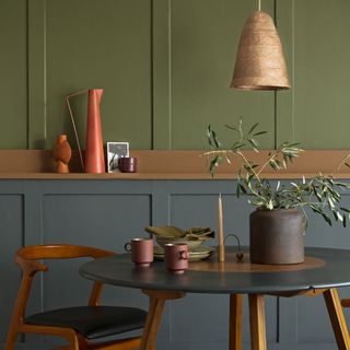 green and grey wall with table and chair
