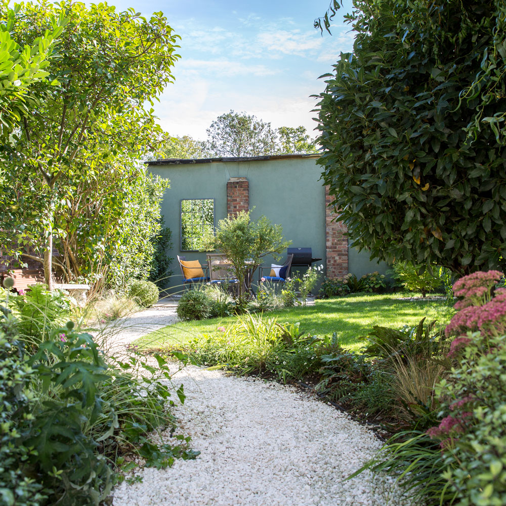 garden with path in middle of sloping lawn