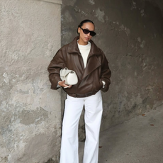 Ingrid in brown jacket and white jeans