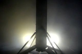 A SpaceX Falcon 9 first stage stands vertical after landing on the drone ship "Just Read the Instruction" on Oct. 5, 2023. The stage was recovered after launching 22 Starlink satellites.