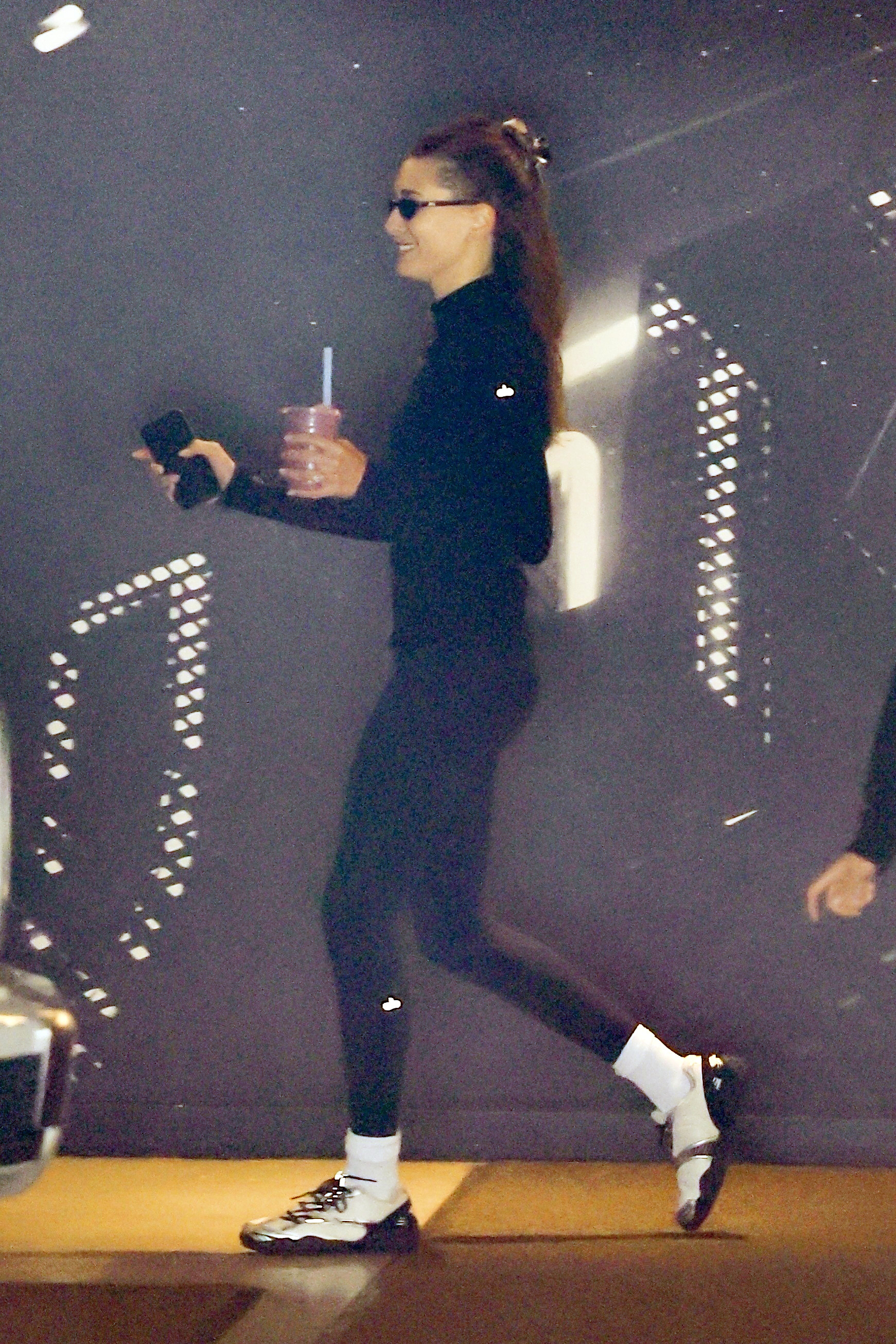 Hailey Bieber's all-black athleisure look debuts a new Fila pair of sneakers.