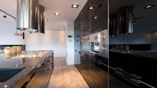 A sleek, narrow kitchen with inbuilt appliances