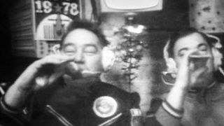 Georgi M. Grechko, left, and Yuri V. Romanenko, enjoy a drink in space.