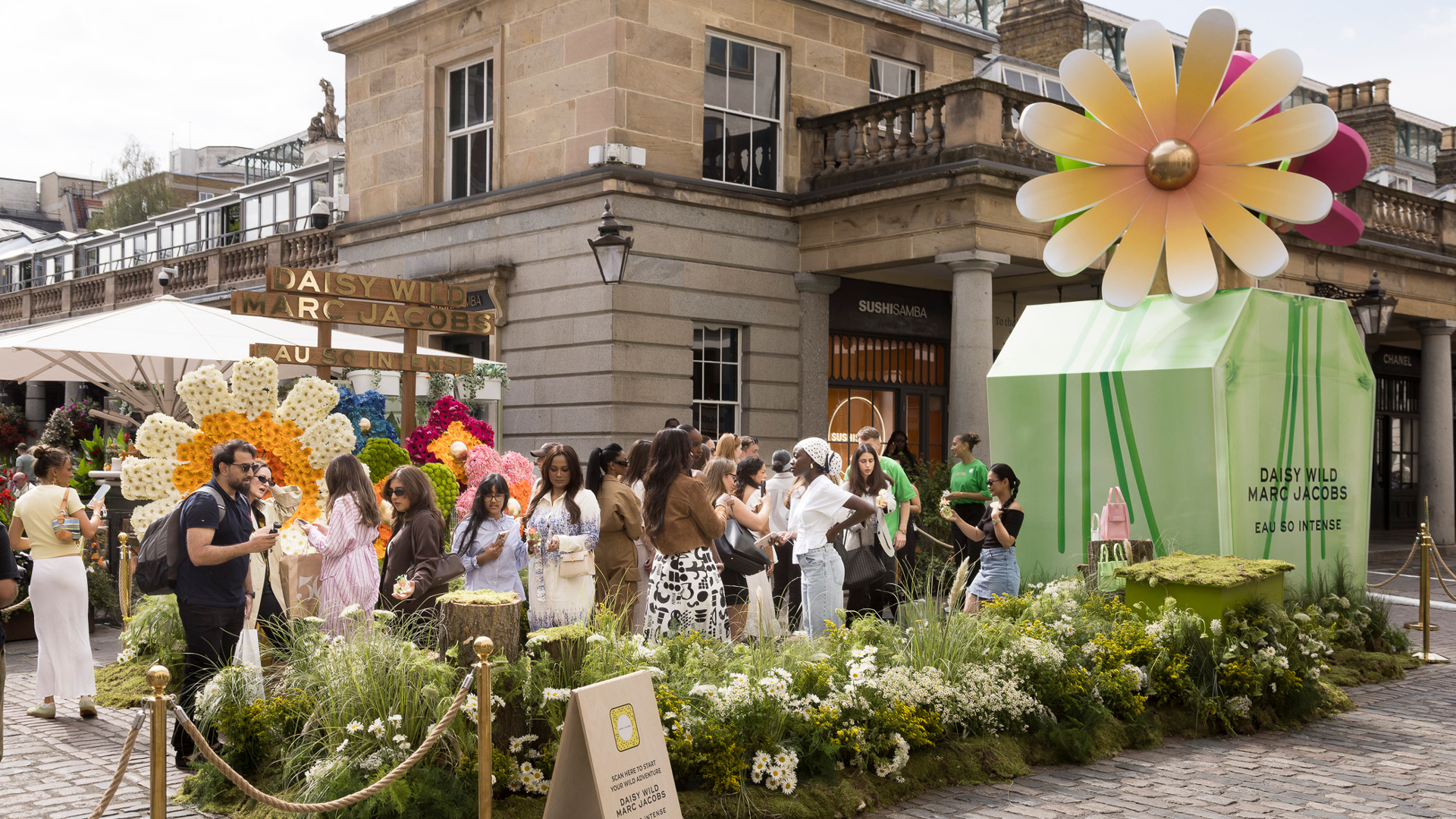Backlash Marc Jacobs pop up - people standing around with a giant flower