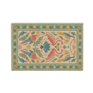 A rectangular green and yellow rug with a flamingo, toucan, leaf and flower pattern adorning it