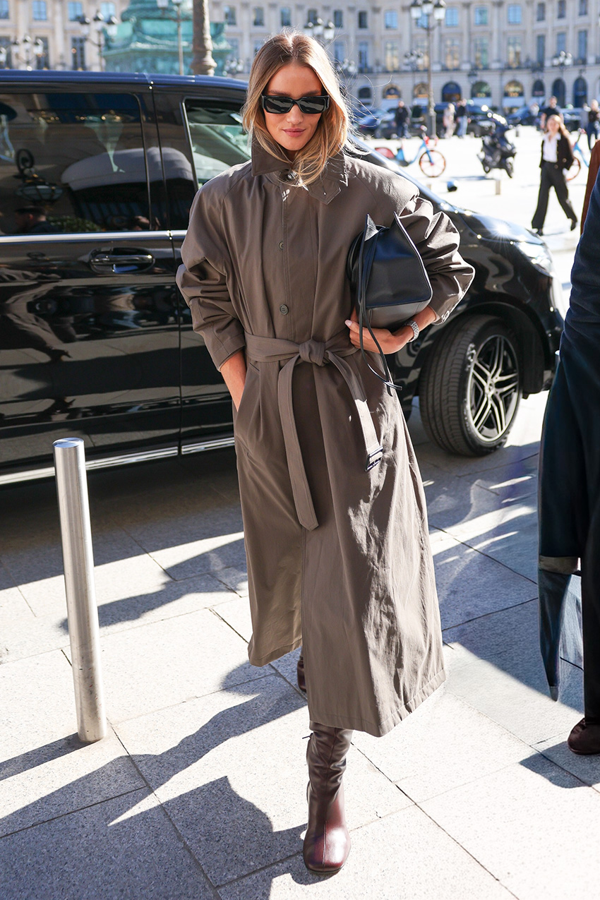 Rosie Huntington-Whiteley wearing a trench coat and boots in Paris