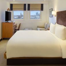 Image of Radisson Hotels room in Leicester Square, with bed and windows looking at Big Ben