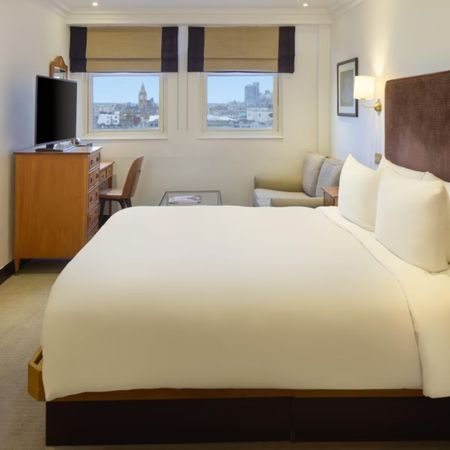 Image of Radisson Hotels room in Leicester Square, with bed and windows looking at Big Ben