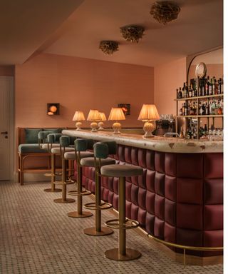 low lit bar with dusty pink walls