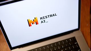 Logo and branding of Mistral AI, developer of the new Codestral coding assistant, pictured on a laptop screen.
