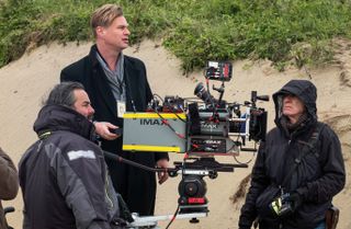 Director Christopher Nolan (center) with IMAX camera on the set of the movie Dunkirk