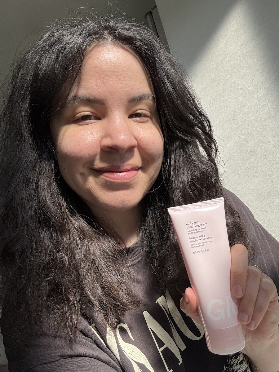 Mica Ricketts holding Glossier Milky Jelly Cleansing Balm after cleansing