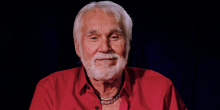 Kenny Rogers smiles and looks into the camera while giving a message to his fans in a 2015 video cal