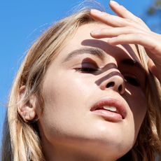 woman shading her eyes from the sun