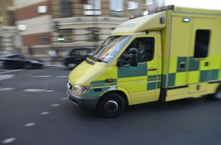 Ambulance on signal turning street corner