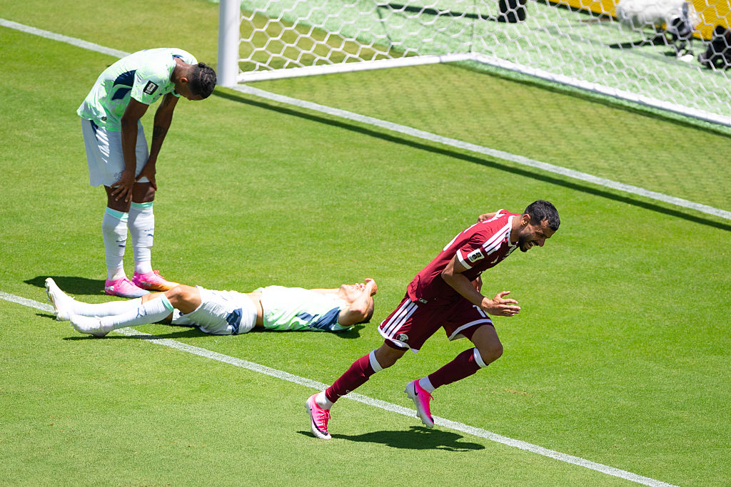 Boualem Khoukhi celebrates Qatar's injury time equaliser