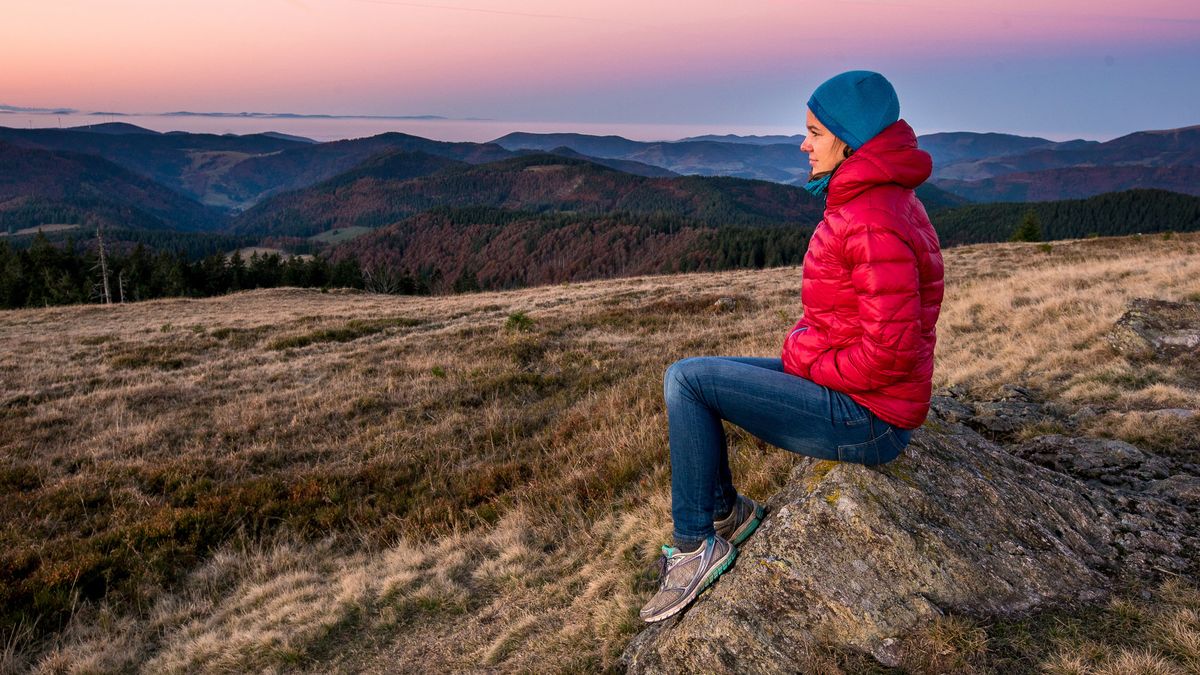 wash a down jacket: hiker wearing down jacket