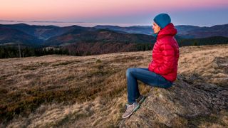 best women's down jackets: hiker wearing down jacket