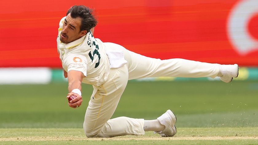 PERTH, AUSTRALIA - NOVEMBER 22: Mitchell Starc of Australia takes a catch off his own bowling to dismiss Zak Crawley of England during day two of the First 2025/26 Ashes Series Test Match between Australia and England at Perth Stadium on November 22, 2025 in Perth, Australia. 