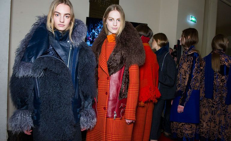 One woman in a black coat and one woman in a red coat