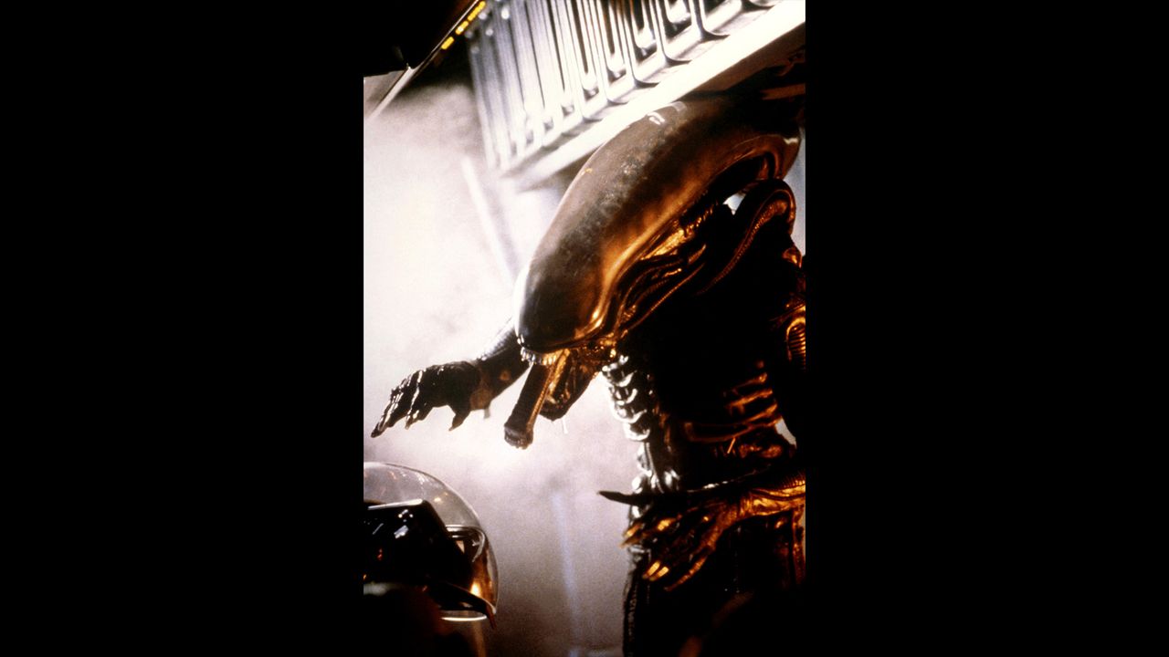 The xenomorph from the iconic science fiction horror film "Alien," directed by Ridley Scott, stands in all its horrifying glory in this set photo.