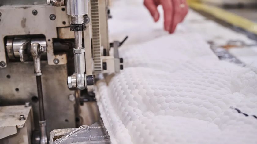 Mattress cover being machine stitched in a factory