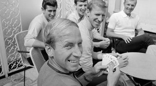 Bobby Charlton holds a full house in a game of cards with team mates (left to right) Peter Bonetti, Martin Peters, Jack Charlton and Bobby Moore. 10th July 1966. (Photo by Fresco/Daily Mirror/Mirrorpix via Getty Images)