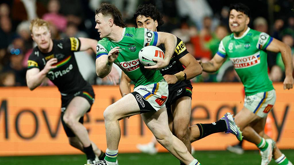 Ethan Strange of Canberra Raiders runs away from the Penrith Panthers defense in the NRL 2025