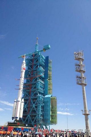 China Long March 2F rocket rolls out to launch pad for Shenzhou 9 mission in June 2012.