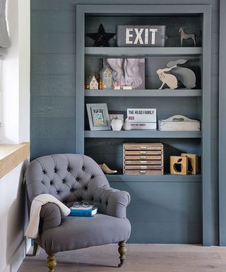 reading nook with grey chair and shelves