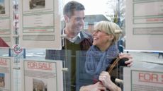 couple in estate agent window